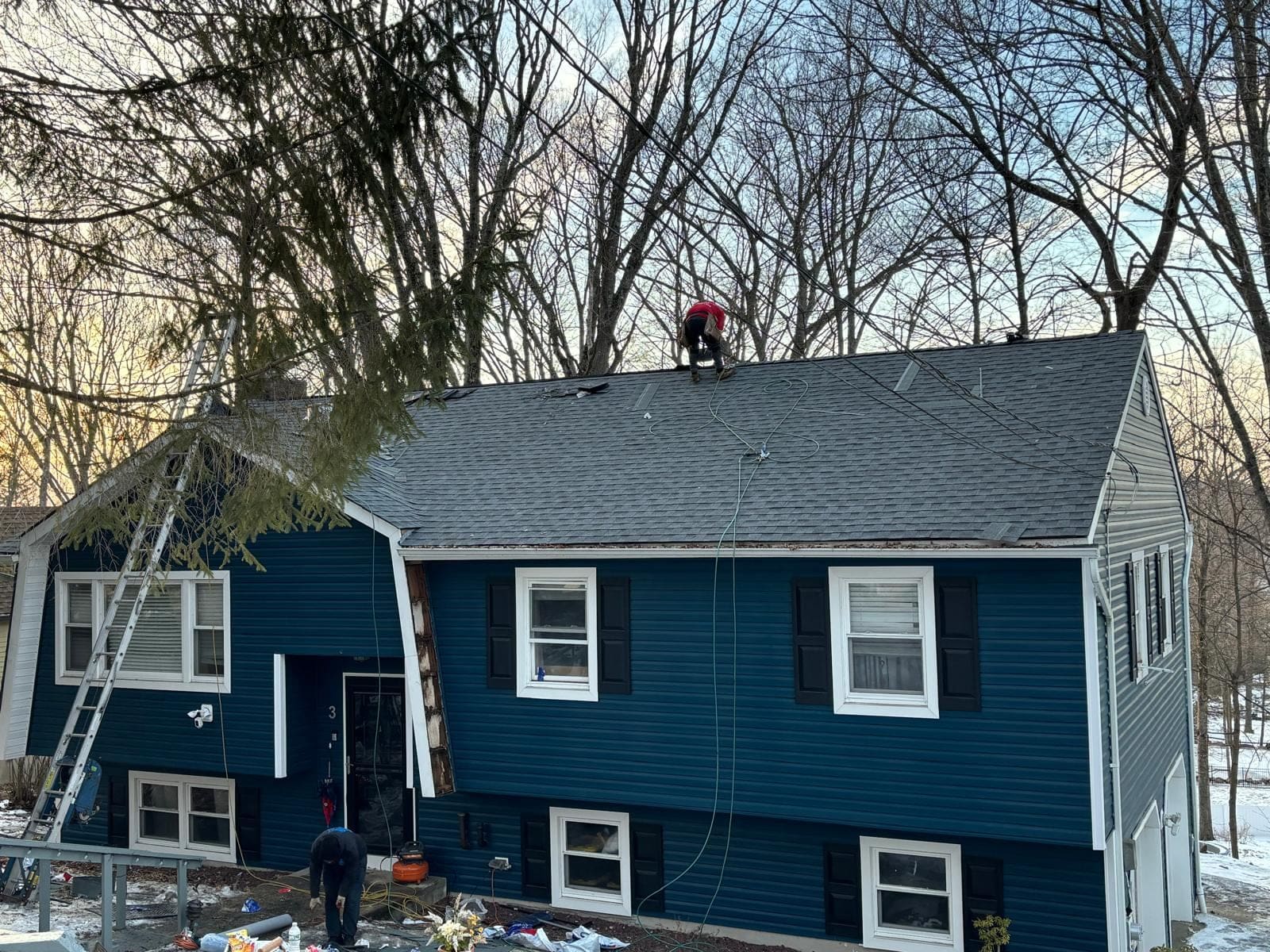 Completed roof replacement on the same blue split-level home