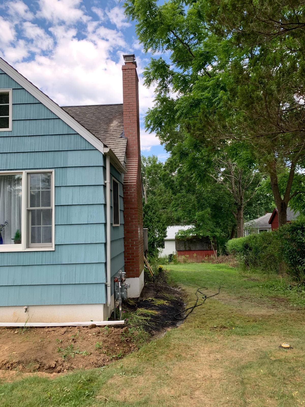 Exterior brick chimney with a new chimney cap on a New Jersey home