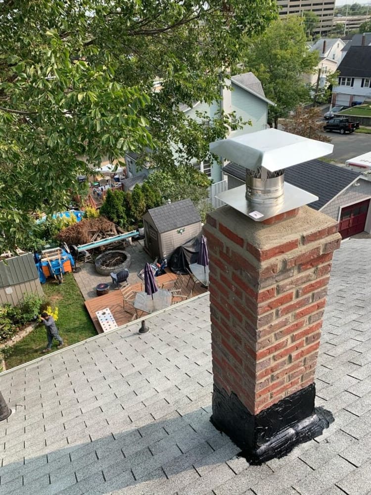Chimney rebuild finished with new cap and sealed base flashing