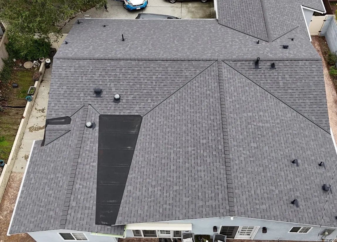 Aerial view of a completed architectural shingle hip roof by Asset Roofing & Chimney