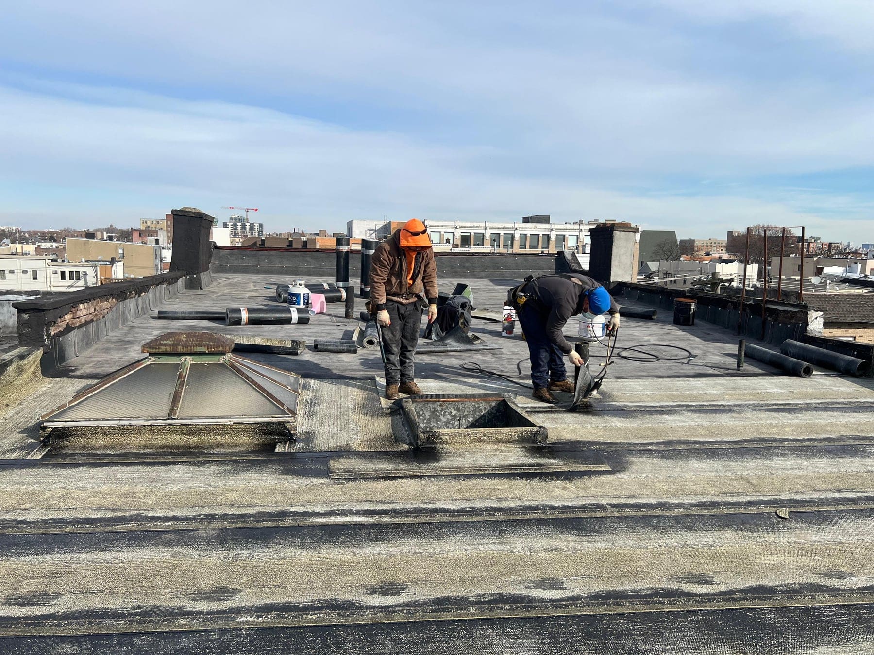 Asset crew repairing a commercial flat roof
