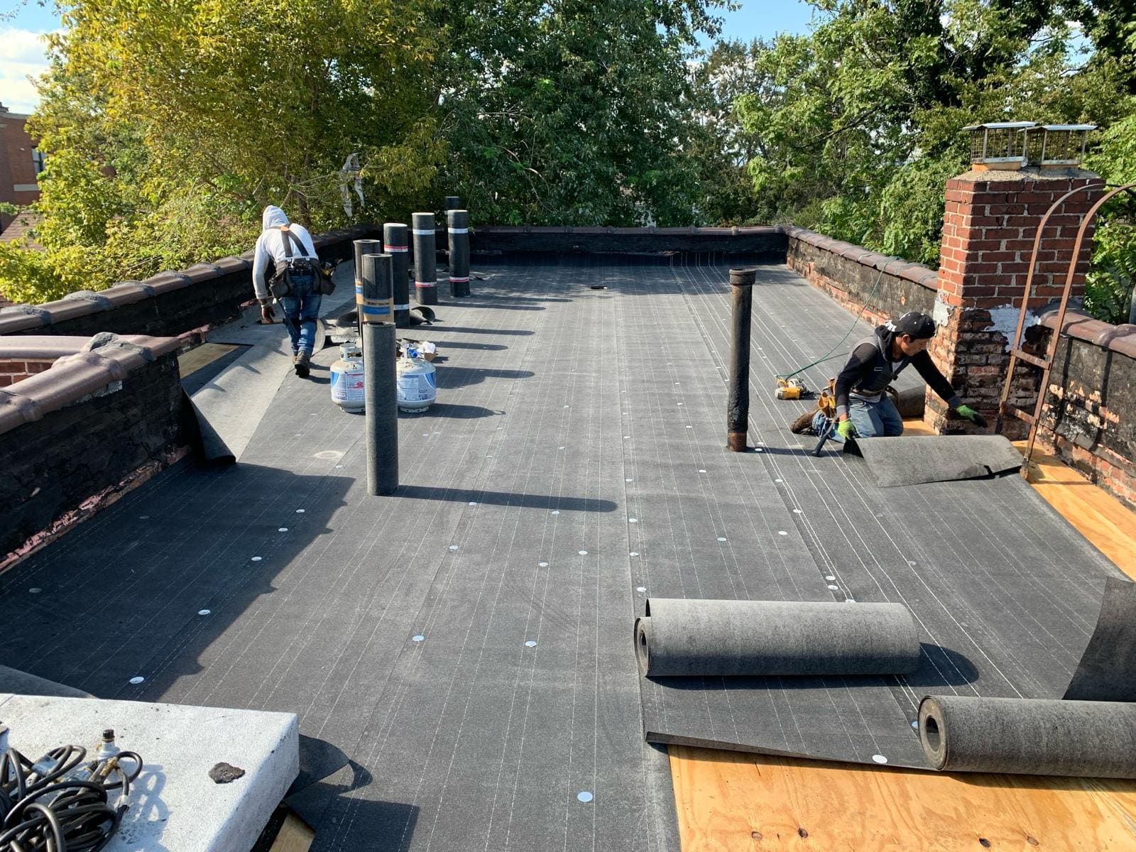 Asset Roofing & Chimney crew installing a new flat roof system on a North New Jersey home