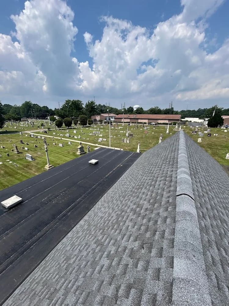 Low-slope roof with new membrane and shingle ridge