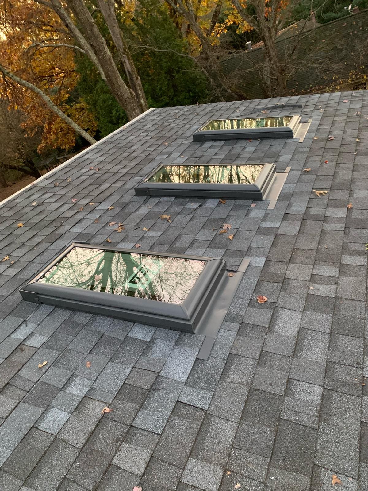 Completed roof replacement with new architectural shingles and three skylights