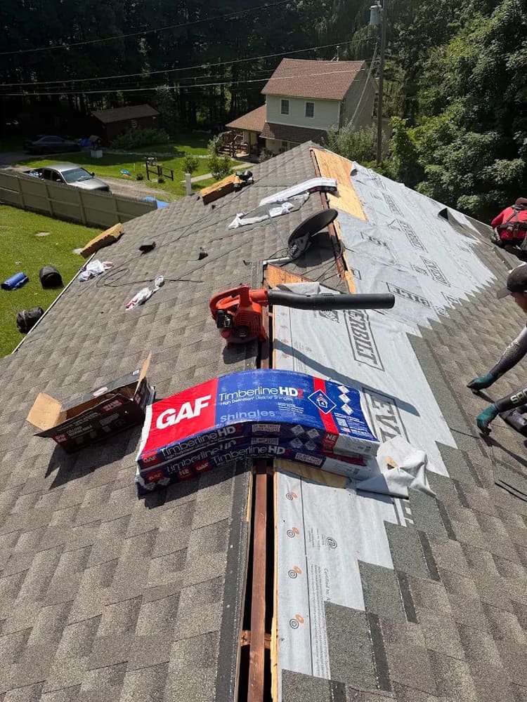 Shingle bundles staged on the roof during a replacement